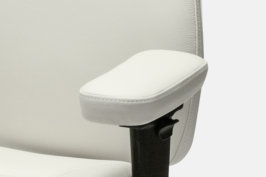Close-up of a padded white chair armrest on a height‑adjustable support.
