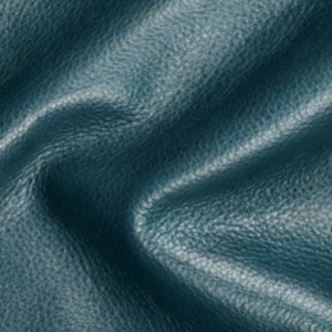 Close-up of textured blue leather with visible grain and soft, natural folds.