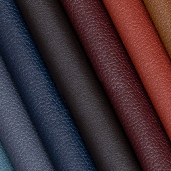 Diagonal rows of textured leather samples in navy, grey, burgundy, coral, and tan colors displaying natural grain patterns.